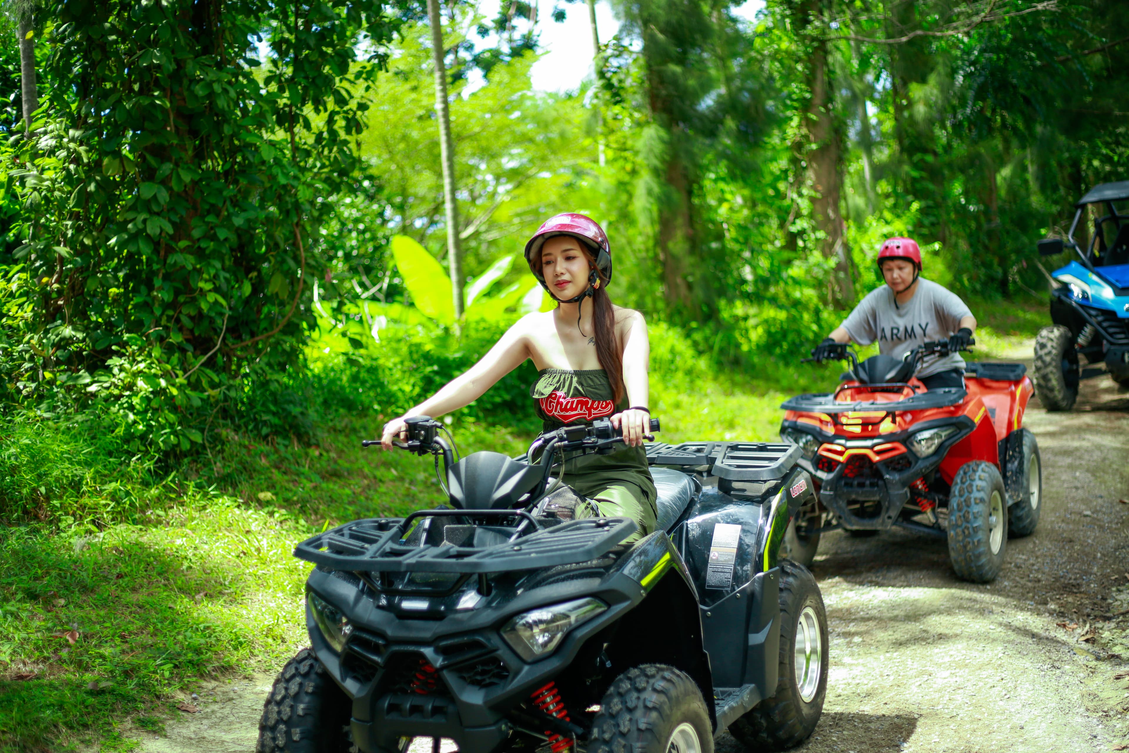 Guest riding an ATV through a jungle trail